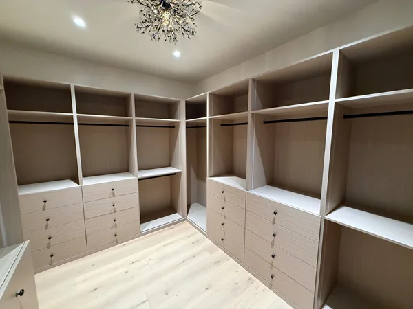 After: walk-in closet with light wood drawer banks, open shelves and hanging sections, Lake Sherwood