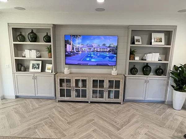 Gray media wall with open display shelving and a glass-front console, Camarillo