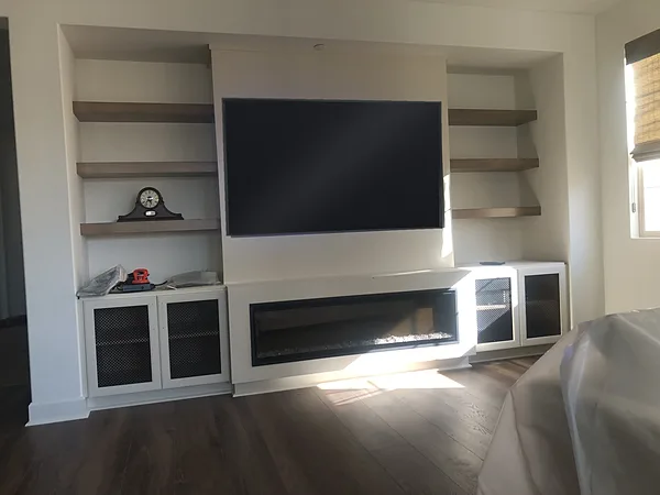 Media wall with a linear fireplace, floating shelves and glass-front cabinets, Camarillo