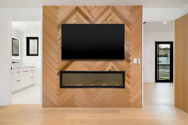 Herringbone oak feature wall with a TV above a linear fireplace, Thousand Oaks