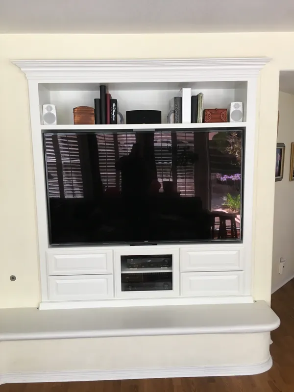 White entertainment center with a TV opening, open shelves above and cabinets below, Thousand Oaks