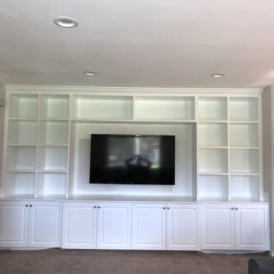 White media wall with open shelving around the TV over shaker base cabinets, Camarillo