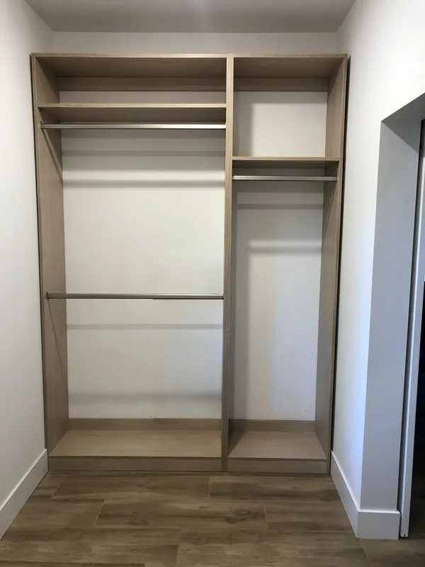 Empty reach-in closet with light oak-look shelving, double and single hanging rods and top shelves, Santa Rosa Valley