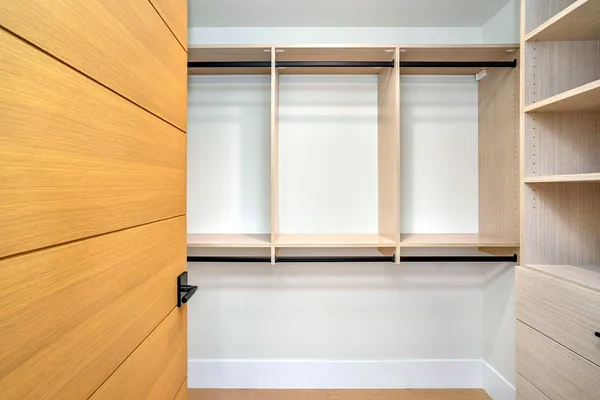 Closet wall with double hanging and shelving in light oak, beside a horizontal-grain oak door, Thousand Oaks