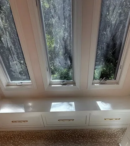 Closet with a cabinet window seat under three skylights, Westlake Village