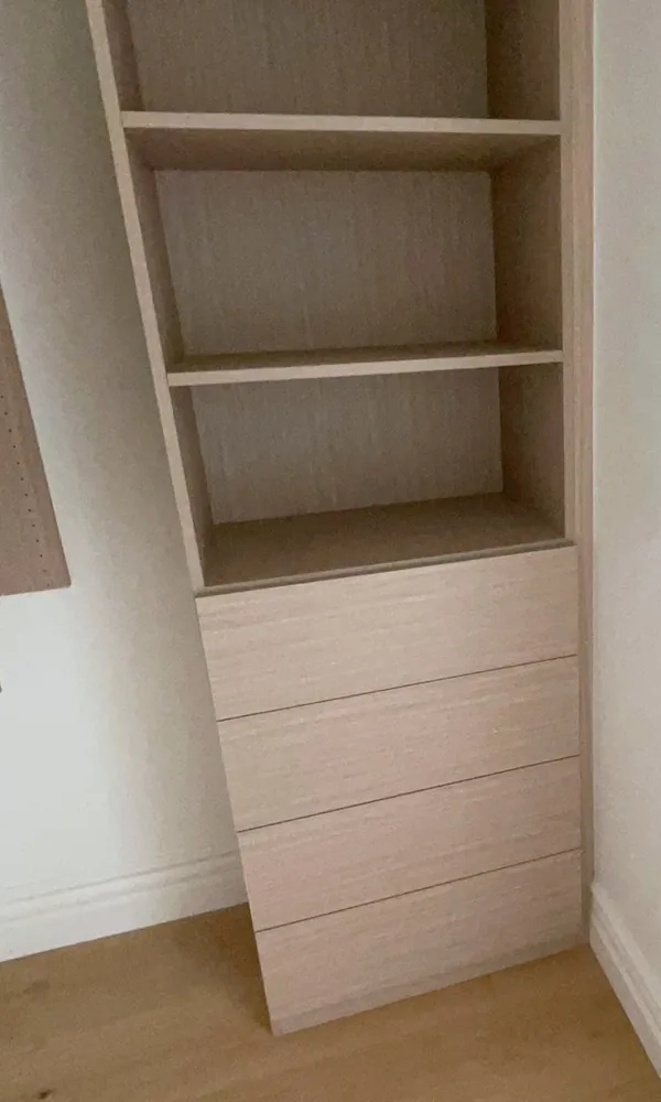 Closet shelf tower over a drawer stack in a light finish