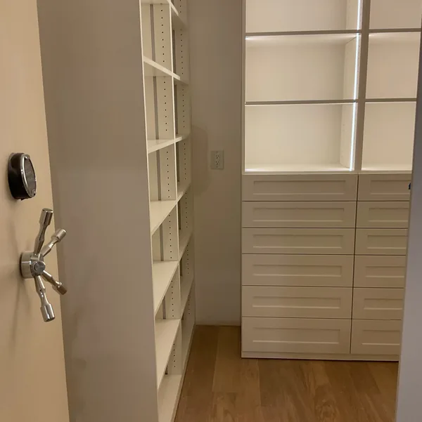 LED-lit open shelves over a white drawer bank