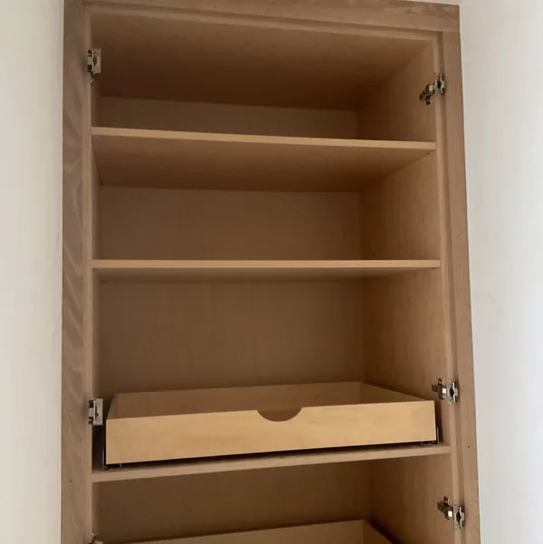 White oak closet interior with shelves and pull-out trays