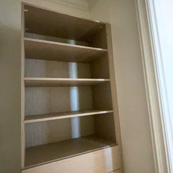 Built-in open shelving bay in a walk-in storage room