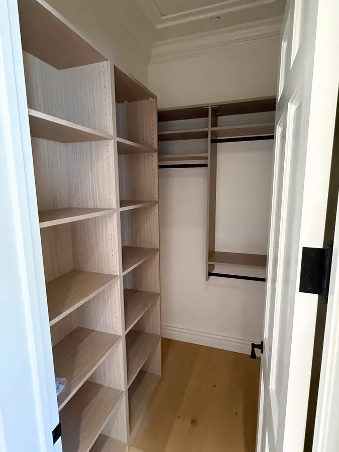 Closet with a tall adjustable shelving tower and double hanging rods, Thousand Oaks