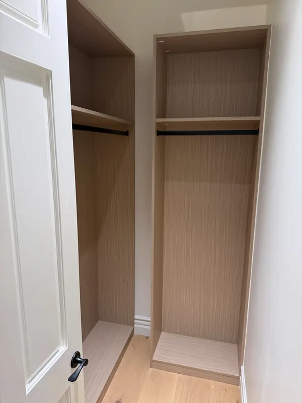 Reach-in closet with two tall hanging sections, each with a rod and top shelf, Thousand Oaks