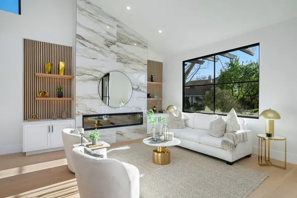 Living room built-in with a marble fireplace wall