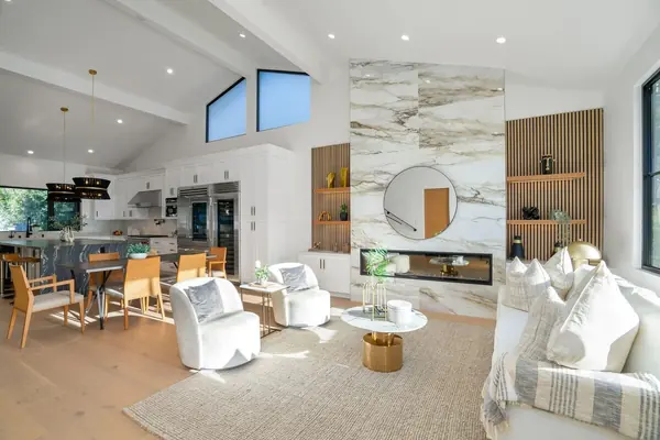 Open great room with slatted oak display shelves and a marble fireplace