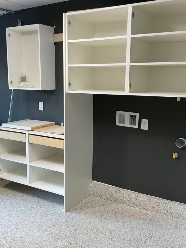 White garage storage cabinets and open shelving on a dark accent wall, Westlake Village
