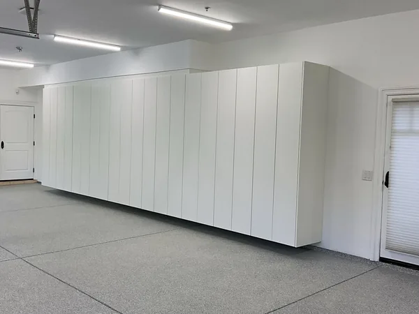Long run of white flat-panel cabinets along a garage side wall, Hidden Hills