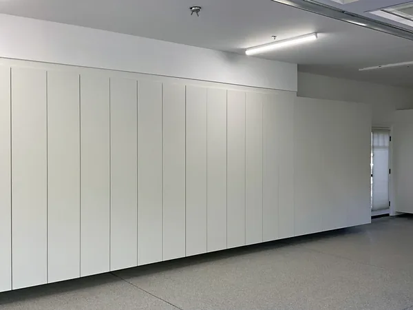 White flat-panel storage cabinets running the length of a garage wall, Hidden Hills