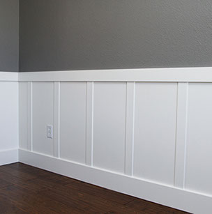 Custom Paint Grade Wainscoting and Crown Molding with a Swiss Coffee Lacquer Finish.