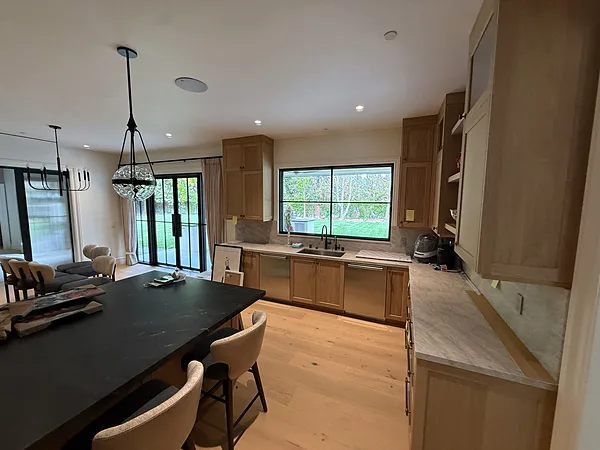 White oak kitchen sink wall with windows and tall cabinets in Lake Sherwood, Westlake Village