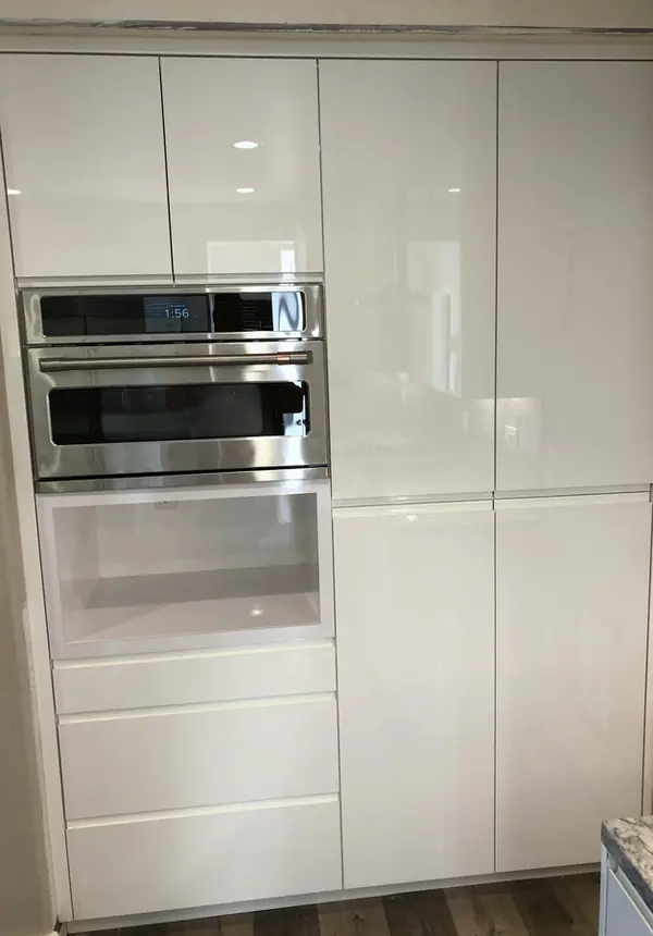 Gloss white slab-door oven and pantry wall, Simi Valley