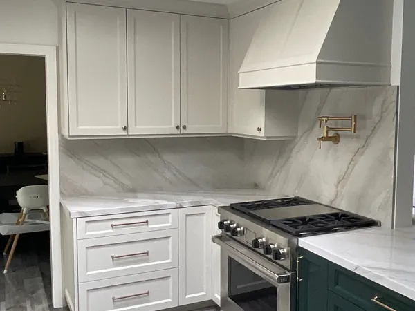White shaker range wall with a paneled hood, pot filler and drawer bank, Thousand Oaks