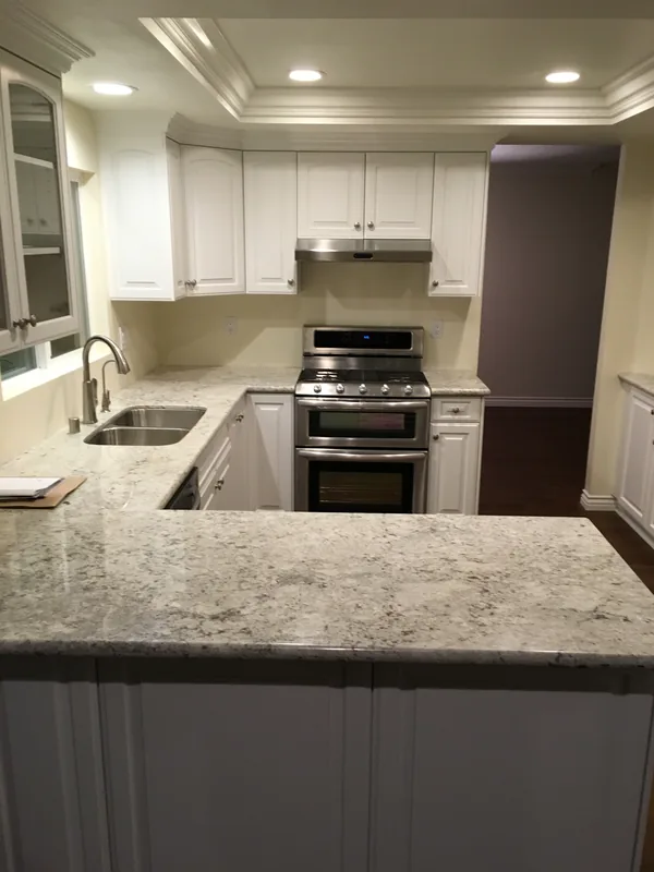 White kitchen with raised-panel cabinets and granite counters, Camarillo