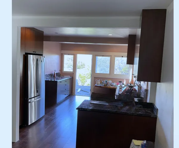 Stained wood kitchen with a fridge surround, a peninsula and a window wall, Moorpark