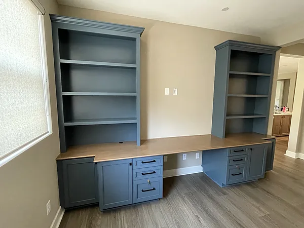 Built-in desk with a wood top, file drawers and blue-gray bookcases, Camarillo