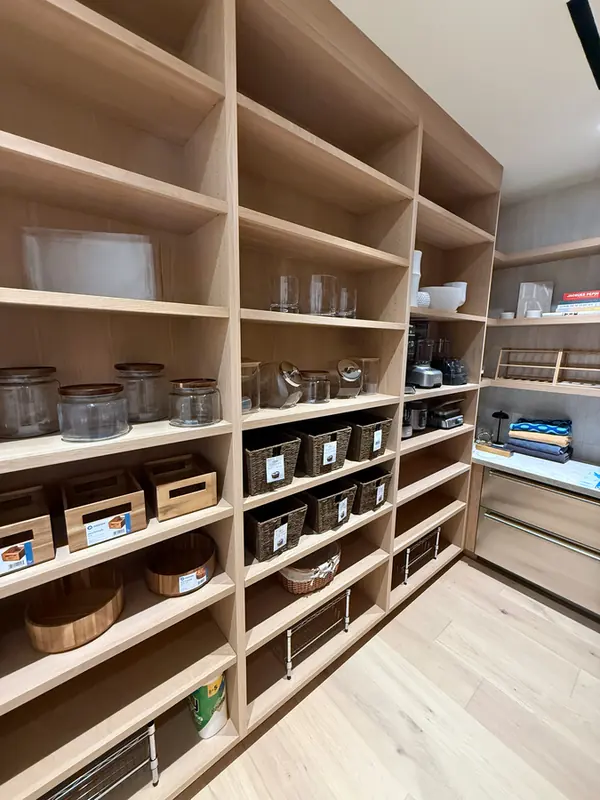 Walk-in pantry lined with open wood shelving, Thousand Oaks