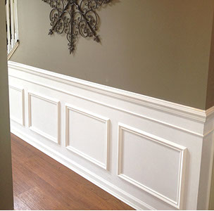Custom Paint Grade Wainscoting and Crown Molding with a Swiss Coffee Lacquer Finish.