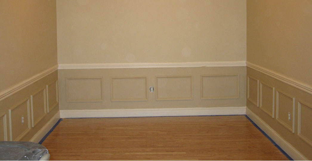 Custom Paint Grade Wainscoting and Crown Molding with a Swiss Coffee Lacquer Finish.