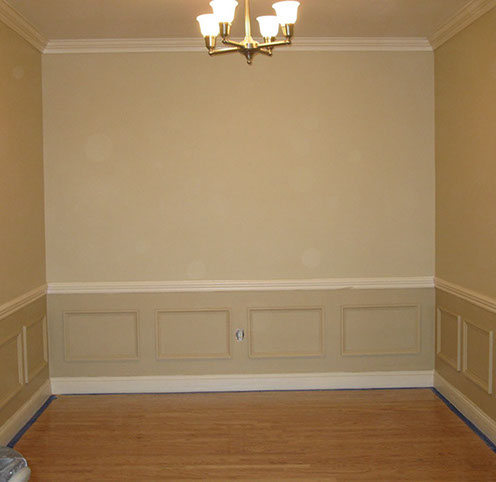 Custom Paint Grade Wainscoting and Crown Molding with a Swiss Coffee Lacquer Finish.