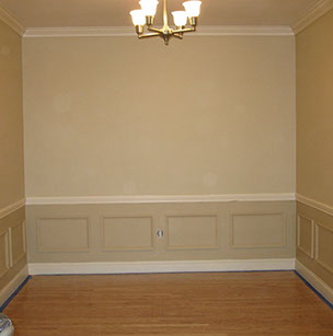 Custom Paint Grade Wainscoting and Crown Molding with a Swiss Coffee Lacquer Finish.