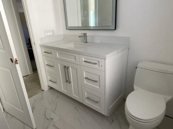 White shaker vanity with drawers and a marble-look top, Simi Valley