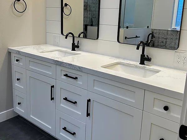 White shaker double vanity with black pulls and a shiplap wall, Thousand Oaks