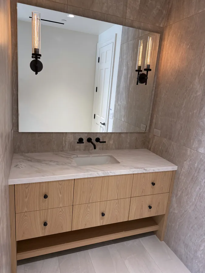 Floating oak vanity with drawers, an open shelf below and a stone top, Thousand Oaks