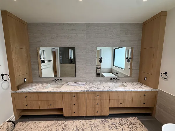 Long white oak double vanity with full-height tower cabinets and a marble top in Lake Sherwood, Westlake Village