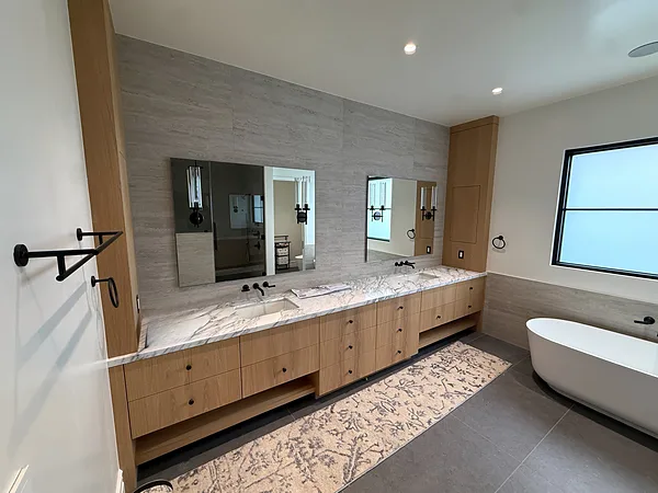 White oak double vanity and tower cabinets beside a freestanding tub in Lake Sherwood, Westlake Village