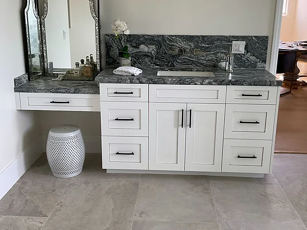 White shaker vanity with a makeup desk, arched mirror and dark stone tops in Somis, near Camarillo
