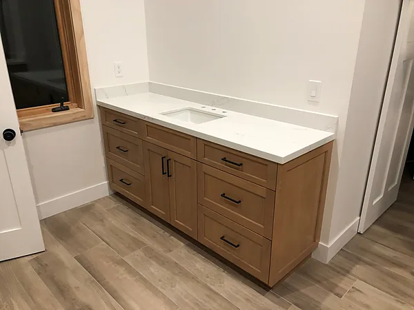 Light oak shaker vanity with drawers, black pulls and a white quartz top in the Santa Rosa Valley, near Camarillo