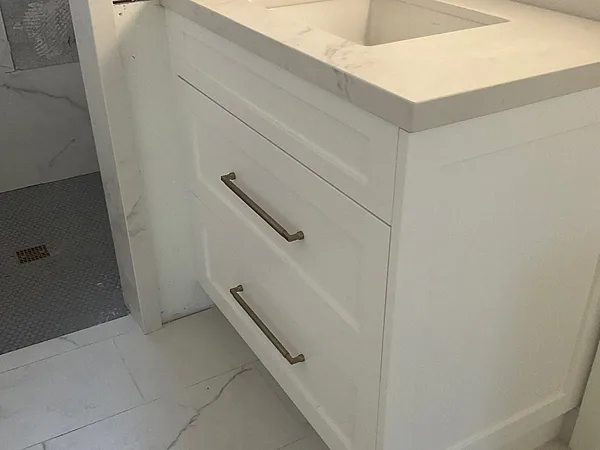 White shaker vanity with long drawer pulls and a white stone top in a Camarillo ADU