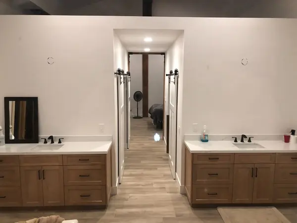 His-and-hers vanities with a barn door